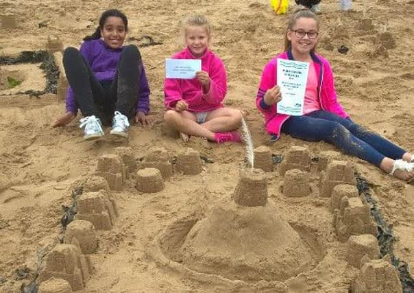 Hartlepool carnival sandcastle competition. 9-13 first place winners Amelia, Hayley and Georgia with their complex castle