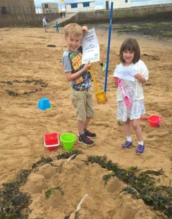 Hartlepool carnival sandcastle competition. 4-8 first place winners Charlie and oppy with their Castle of Victory
