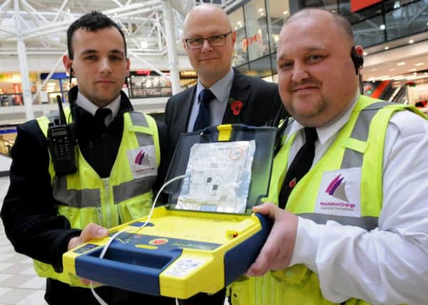 Defibs4Hartlepool members, Middleton Grange Shopping Centre security staff Adam Goodwin, left, and Ray Hughes, right, with centre manager Mark Rycraft, with a defibrillator