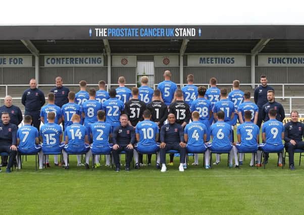 Hartlepool United's first team squad line up in front of the renamed Prostate Cancer UK Stand at Victoria Park.