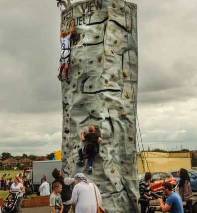 Scaling the heights on the climbing wall at the Rift House Family fun day on Saturday.