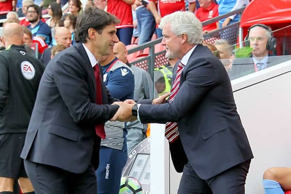 Middlesbrough boss Aitor Karanka (left) and Stoke City manager Mark Hughes shake hands prior to the Premier League match at the Riverside Stadium. Photo by Richard Sellers/PA Wire.