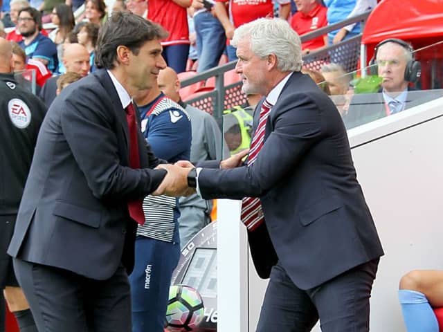 Middlesbrough boss Aitor Karanka (left) and Stoke City manager Mark Hughes shake hands prior to the Premier League match at the Riverside Stadium. Photo by Richard Sellers/PA Wire.
