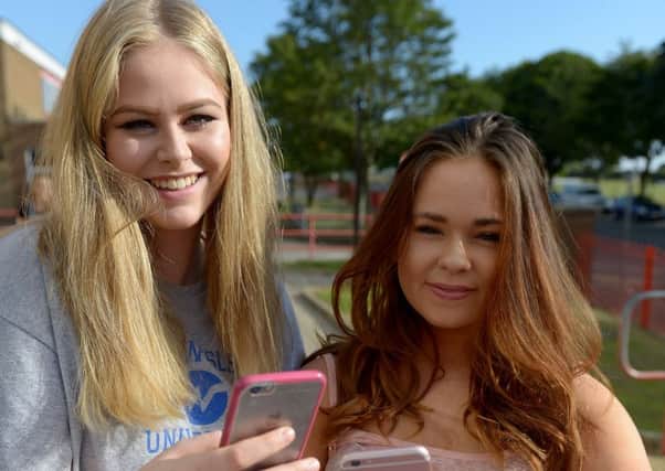 Imogen Joy (left) and Emily Ray from English Martyrs School and Sixth Form College with their results. Picture by FRANK REID