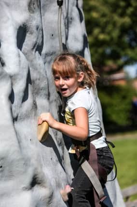 Sophie Welch on the climbing wall at a family funday in Rossmere Park, Hartlepool. Picture: TOM BANKS
