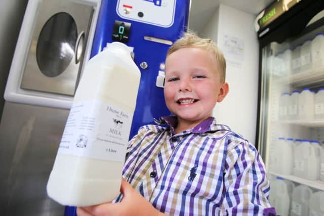 Home Farm in Elwick, near Hartlepool, has installed a raw milk vending machine, where the public can purchase it. Pictured with some of the milk is 7-year-old Louis Richmond. Picture: TOM BANKS