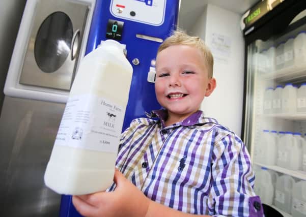Home Farm in Elwick, near Hartlepool, has installed a raw milk vending machine, where the public can purchase it. Pictured with some of the milk is 7-year-old Louis Richmond. Picture: TOM BANKS