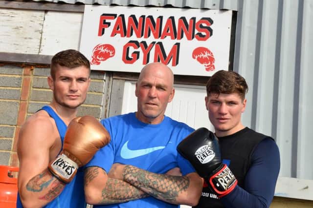Boxing trainer Neil Fannan (centre) with brothers Daniel and Peter Cope (right)
