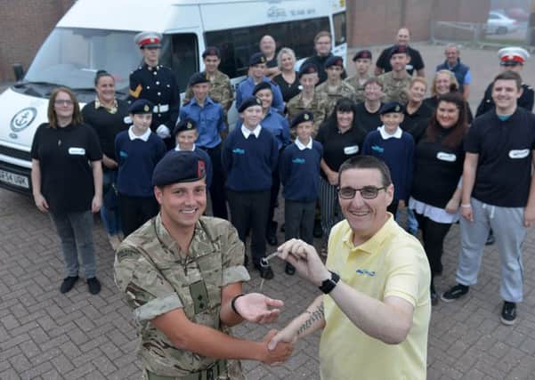 Stephen Picton (left) from Helping Hands hands over the keys to the mini bus to 2nd Lt David Quinn officer in charge Hartlepool Sea Cadets, as cadets and helping hands members look on . Picture by FRANK REID