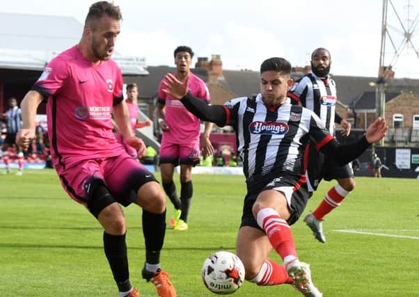 Jordan Richards is tackled by Grimsby's Danny Andrew