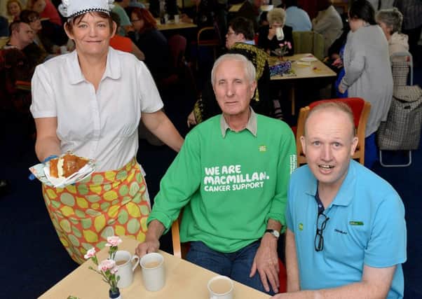 Derek Readman from Macmillan is served coffee  and cake by Roaring Mouse group members Shirley Wray and Jonathan Payne at the Roaring Mouse Macmillan coffee afternoon.  Picture by FRANK REID
