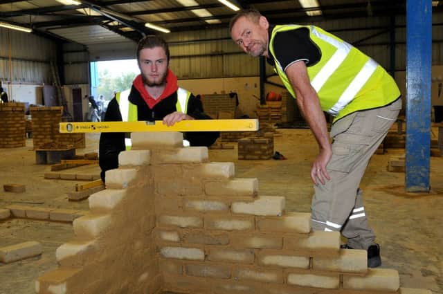 Bricklaying instructor Mike Bramley (right) with level 2 student Owen Bennett.