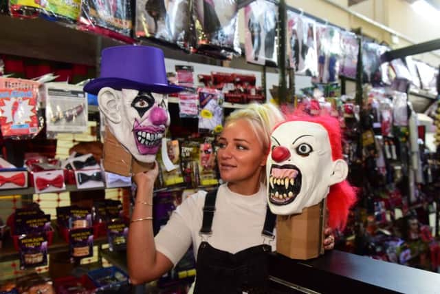 Sophie Harcourt of The Halloween Shop, Market Hall, Hartlepool with their popular clown masks.