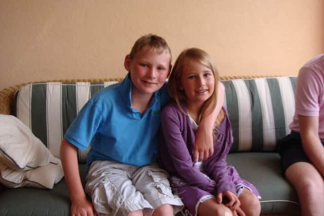 George Wall, 11, with his sister Sophie on holiday in Mallorca.