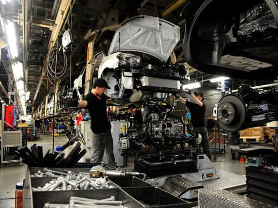 Workers at Nissan in Sunderland working on the Qashqai. Pic: PA.