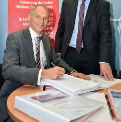 Signing their contract are Duncan Clark (Dong Energy) (left) with Ivan Coward (JDR Cables). Picture by FRANK REID