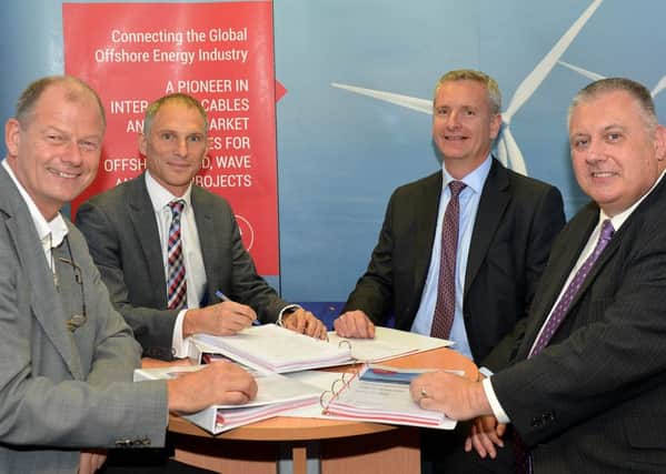 Signing their contract are (left to right) Peter Steen Ejler and Duncan Clark (Dong Energy) with Ivan Coward and John Prince (JDR Cables). Picture by FRANK REID