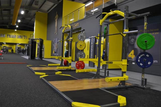 A squat rack at an  Xercise4Less gym.