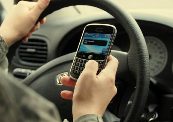Calls have been made to take more action against drivers who use their phone while behind the wheel.