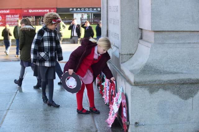 Local school children placing their wreaths at the Cenotaph at the Armistice Parade in Victory Square, Hartlepool.