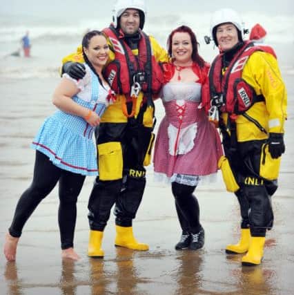Ken Hay(left) and Garry Waugh of Hartlepool RNLI with two of the participants at the Boxing Day dip event at Seaton Carew. Picture by Tom  Collins