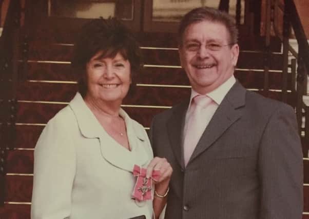 Wendy McLoughlin with husband John when she received her MBE.