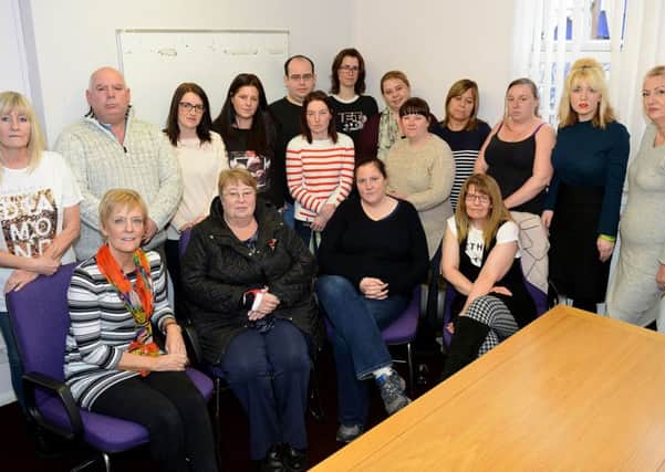 Jan Dobson (sitting left) manager of the Patch Family Support Group, with Staff, volunteers and service users.  Picture by FRANK REID