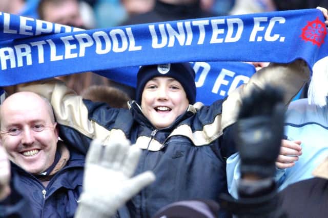 A young fan gets into the spirit of the FA Cup occasion.