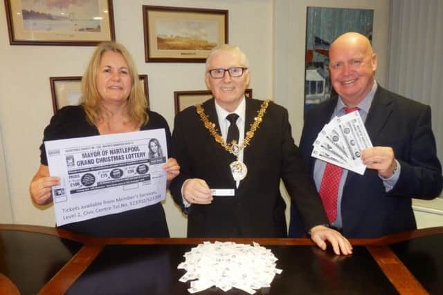 Hartlepool Mayor Councillor Rob Cook draws the winning ticket for the Christmas lights switch-on. Looking on are council officers Karen Mason and David Worthington