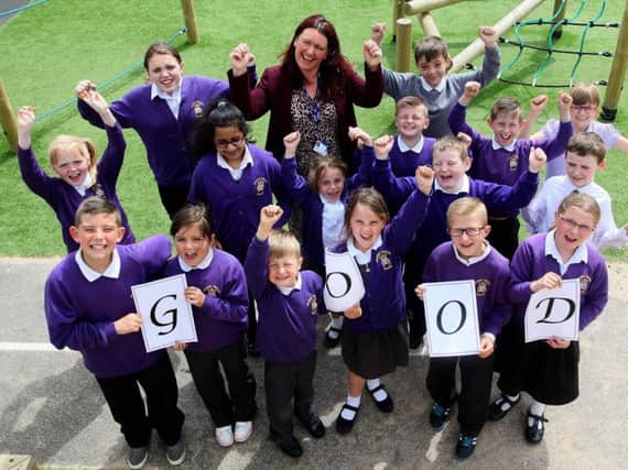 Headteacher Leanne Yates and pupils from Grange Primary School celebrate their Ofsted success