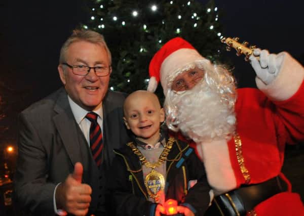Bradley Lowery joins Santa, and Durham County Council Chairman Edward Bell to help switch on the Christmas tree lights at Durham's County Hall.