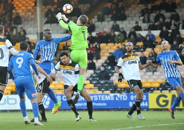 Toto Nsiala challenges Port Vale keeper Jak Alnwick