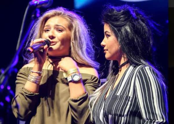 Georgia left, and Olivia Crawford receiving their award on stage at the Newcastle O2 Academy