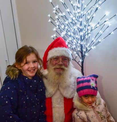 Santa Claus with Maddison Bradley (8) and Emily Wood (4) of Easington Village at the Jack Richardson Christmas Lights switch-on party at his house Seaview Villa, Park Lane, Horden on Thursday night.