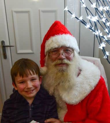 Santa Claus with Kainan Paul (7) at the Jack Richardson Christmas Lights switch-on party at his house Seaview Villa, Park Lane, Horden on Thursday night.
