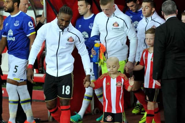Bradley Lowery walks out on to the Stadium of Light pitch hand in hand with Jermaine Defoe as mascot at the game against Everton.