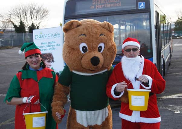 Bus drivers Wendy Fletcher and Keith Bagguley with Daisy Bear, of the charity Daisy Chain.