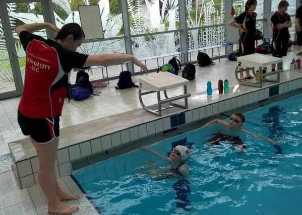 Coach Katherine Hill teaches youngsters in the pool.