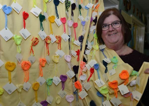 Diane Stephens with one of the knitted bombardment murals that hang in the Heugh Battery Museum, showing the names and ages of  victims.