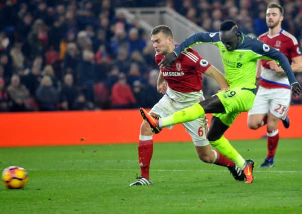 Ben Gibson tries to halt Sadio Mane at the Riverside. Picture by TOM COLLINS
