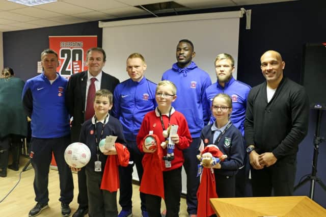 From left to right, Hartlepool United Community Sports Foundation officer Keith Nobbs, Cleveland Polices Police and Crime Commissioner Barry Coppinger, Pools players Michael Woods, Toto Nsiala and Nicky Featherstone, and former Pools assistant manager Curtis Fleming, with school pupils at the event at Victoria Park.