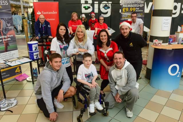 Alfie Smith (front centre) with volunteers who had been riding bikes to raise money for Alfie at Middleton Grange Shopping Centre, Hartlepool, from left back row Alfie's mum Annie Stalley, his aunt Mel Stalley, Lisa Nightingale, Hartlepool Mail, and Steven Clarke. Front are Marc Irish (left) and Steve Irish