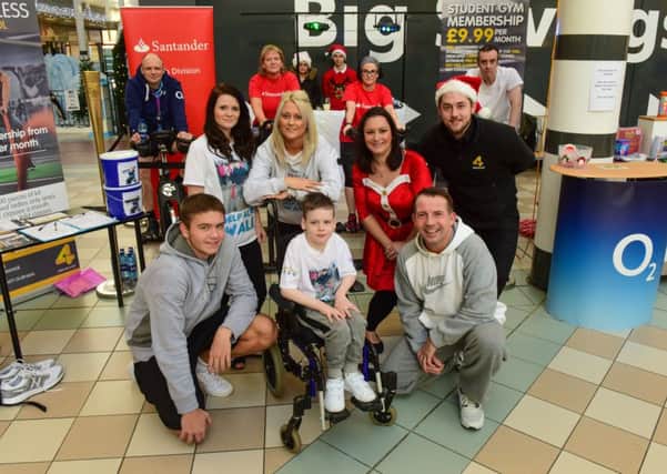 Alfie Smith (front centre) with volunteers who had been riding bikes to raise money for Alfie at Middleton Grange Shopping Centre, Hartlepool, from left back row Alfie's mum Annie Stalley, his aunt Mel Stalley, Lisa Nightingale, Hartlepool Mail, and Steven Clarke. Front are Marc Irish (left) and Steve Irish
