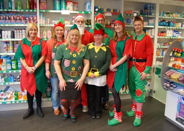 Staff at West View Pharmacy in festive dress as part of their fundraising for Alice House hospice