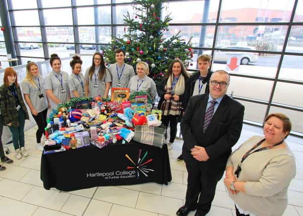 Robin Hardy of Co-op Funeralcare and Lynne Craddock of Hartlepool College of Further Education with students and some of the gifts