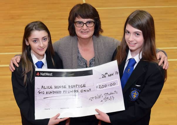 St Hilds pupils Mia Blenkinsopp and Amy Riddle present a cheque for Â£200 to Janice Forbes from the hospice.