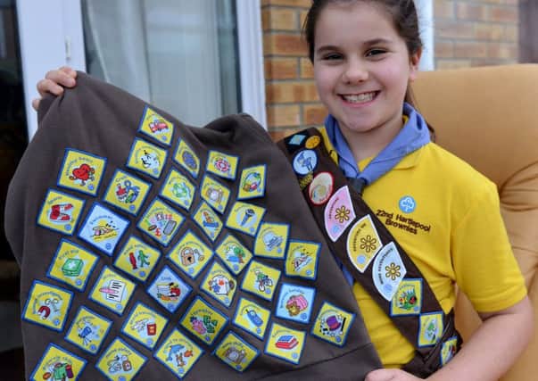 Brownie Hannah (9) with with her collection of badges.  Picture by FRANK REID