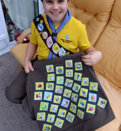 Brownie Hannah (9) with with her collection of badges.  Picture by FRANK REID