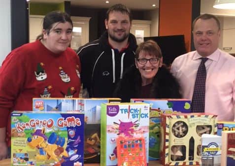 Mick Sumpter of MKM (far right) with workers from Belle Vue Community Sports and Youth Centre and some of the Give A Little Gift presents.