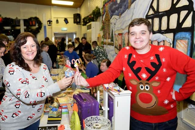Janice Neesam buys Candy Cane's from her son Maxwell during the Catcote Academy Christmas Fayre.  Picture by FRANK REID